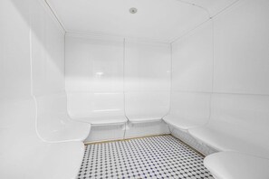 A bathroom with white walls, a tiled floor, and a shower area. - Regency Isle 806 | Gulffront Condo w/Stunning Views, Pools & Sauna (Orange Beach)