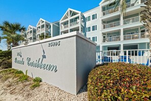 A beachfront hotel with a sign reading "Franklin Caribbean".