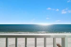 A beach view from a balcony with a railing, ocean, and clear sky. - Edgewater 82- floor to ceiling glass doors, 2 bedrooms, low density complex (Gulf Shores)