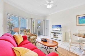 Relax in this stylish living room with a sofa, coffee table, and armchair, perfect for unwinding in front of the flat-screen TV.