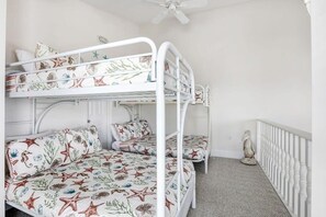 A bunk bed room with a white ceiling fan, a decorative bird sculpture, and a white railing. - Camp David Side A: pvt. pool, beach view, sleeps 9 (Gulf Shores)