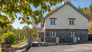 A two-story house with a stone facade and a small porch. - Cunsey Lodge with Woodfired Hot Tub and stunning views (Cunsey)