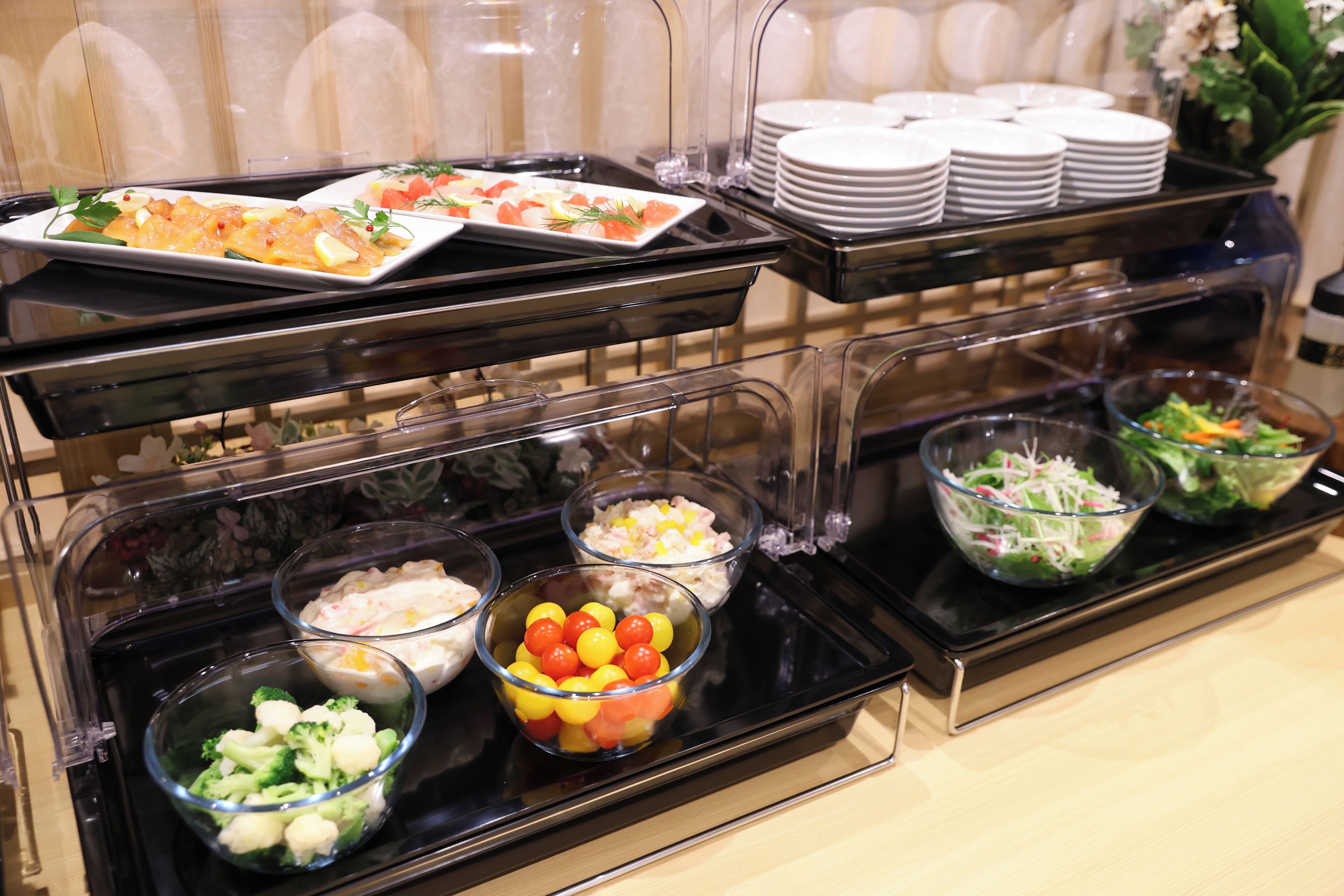 A buffet setup with various food items and dishes.