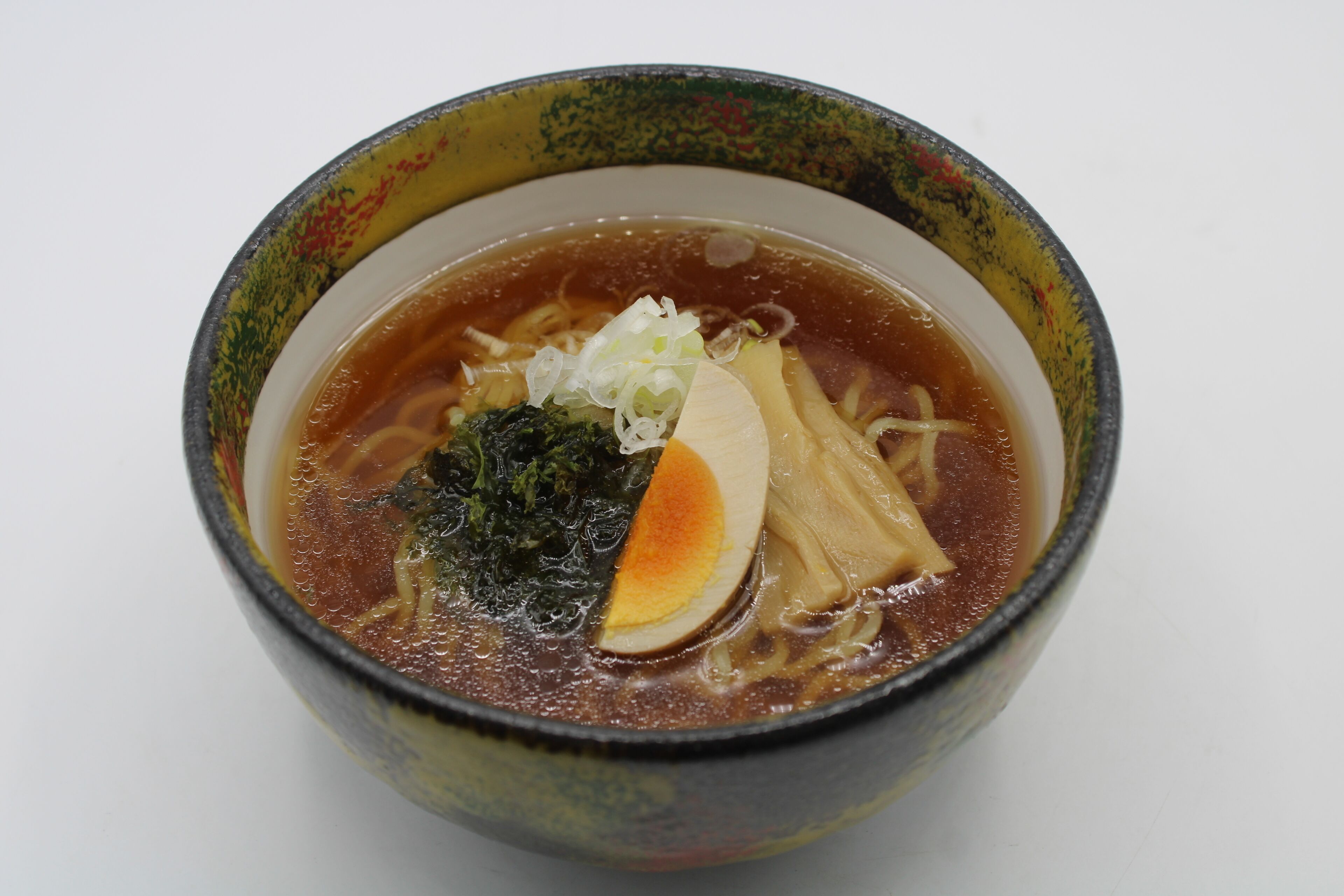 A bowl of ramen with toppings.