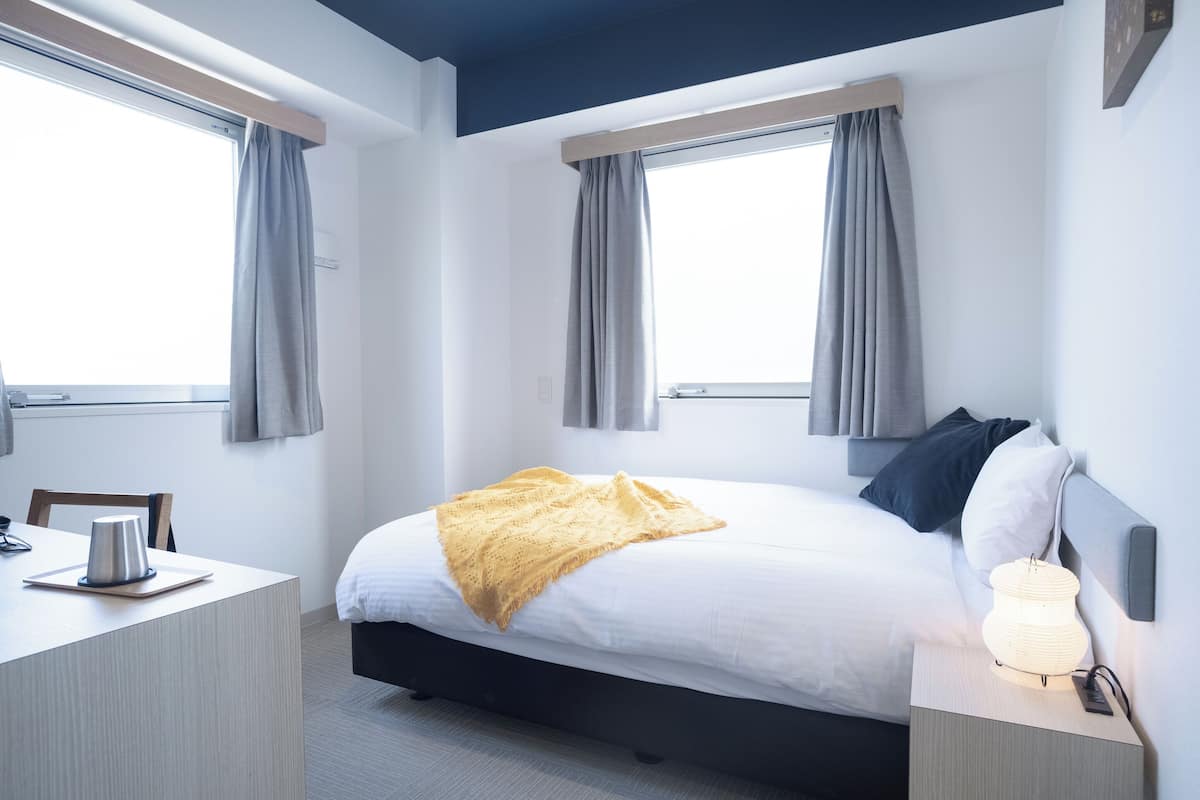 Camas com colchões pillow-top, escrivaninha, cortinas blackout