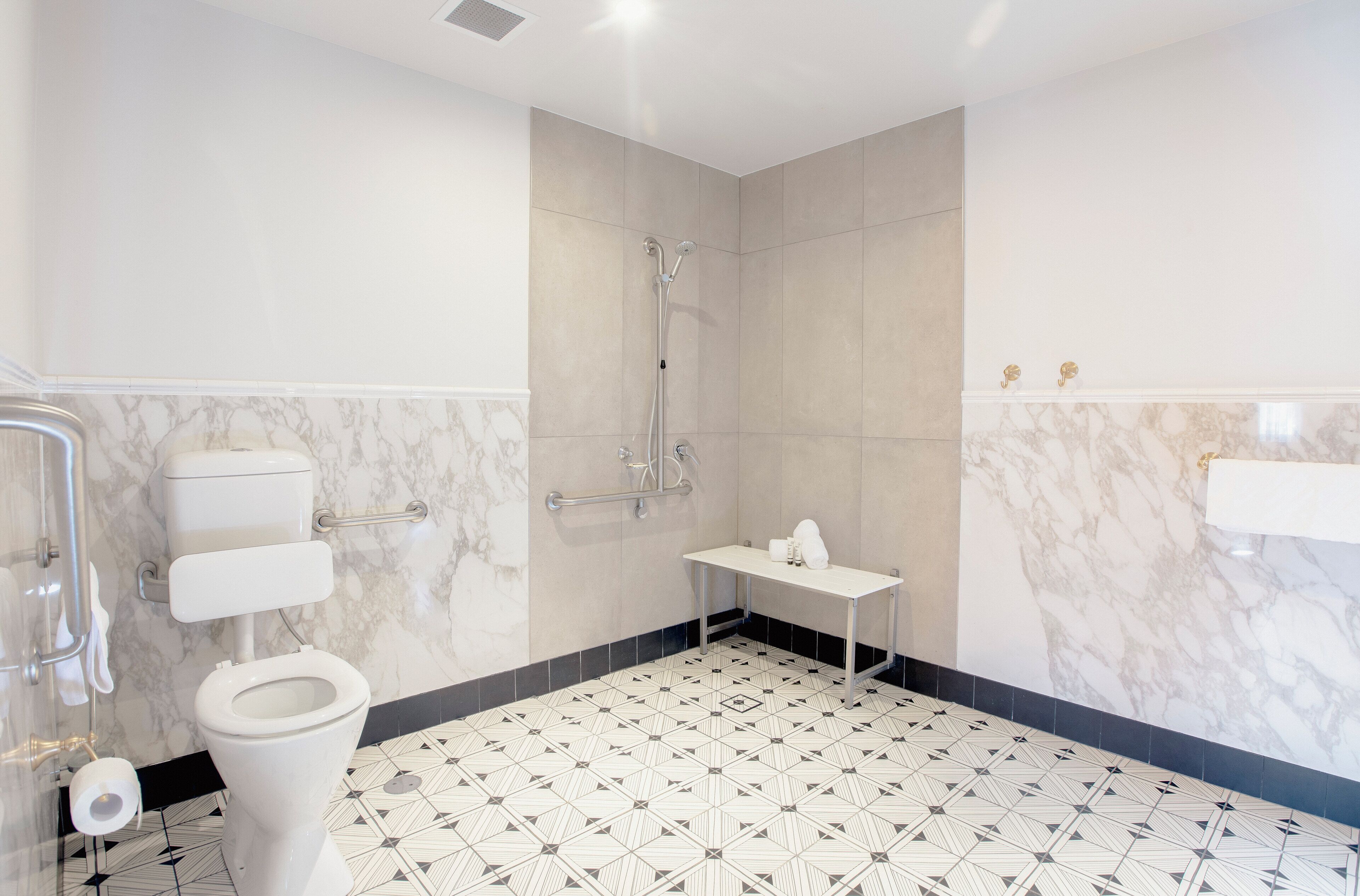 Un baño moderno con inodoro, ducha y lavamanos.