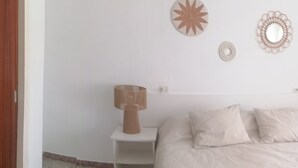A bedroom with a bed, two bedside tables, and wall decor. - 3354 - LA SOLANA 3-28 VERY GOOD SITUATION, 2ND LINE OF THE BEACH (80m) IN THE URBANIZATION OF SANTA MARGARITA. (Roses)