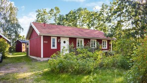 A red wooden house with a number '502' on the side, surrounded by greenery and trees. - Cozy home in ålem with kitchen (Ålem)