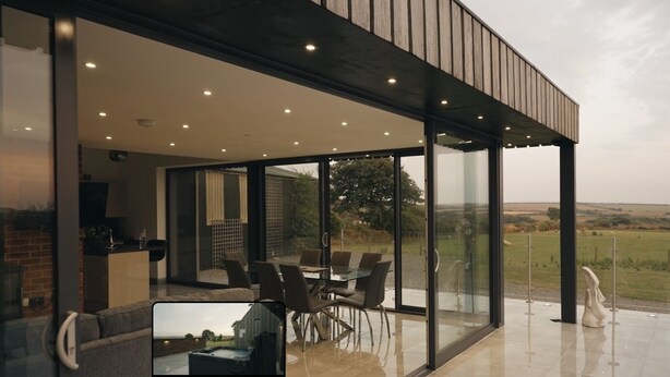 A modern outdoor dining area with a glass enclosure, a hot tub, and a view of the countryside. - Hollywood vibes in pembrokeshire (Haverfordwest)