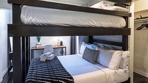A bunk bed room with a desk, a lamp, and a hanging coat rack. - The Queen Sacrifice! Galleria, Medical Center 2BR+1 (Houston)