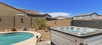 Airy desert home with an enclosed yard, private pool, hot tub, firepit, & W/D