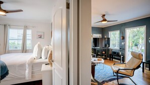 A bedroom with a bed, a chair, and a TV in the living area. - Vistamar Waterfront Beach Abode -walk to the Beach (Fort Lauderdale)