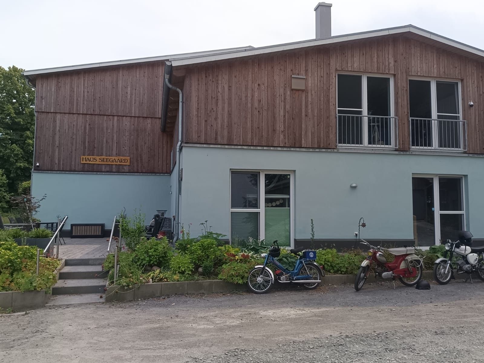 A two-story building with a wooden exterior and a sign reading 'HAUS SEEGAARD'.