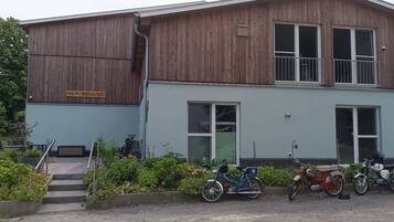 A two-story building with a wooden exterior and a sign reading 'HAUS SEEGAARD'.