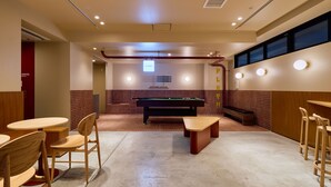 A billiards room with a pool table, chairs, and tables. - Hotel Plus Hostel TOKYO ASAKUSA 2 (Tokyo)