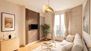 A modern living room with a sofa, a TV, a plant, and a wooden floor. - Unique Parisian flat near Gare Montparnasse (Paris)