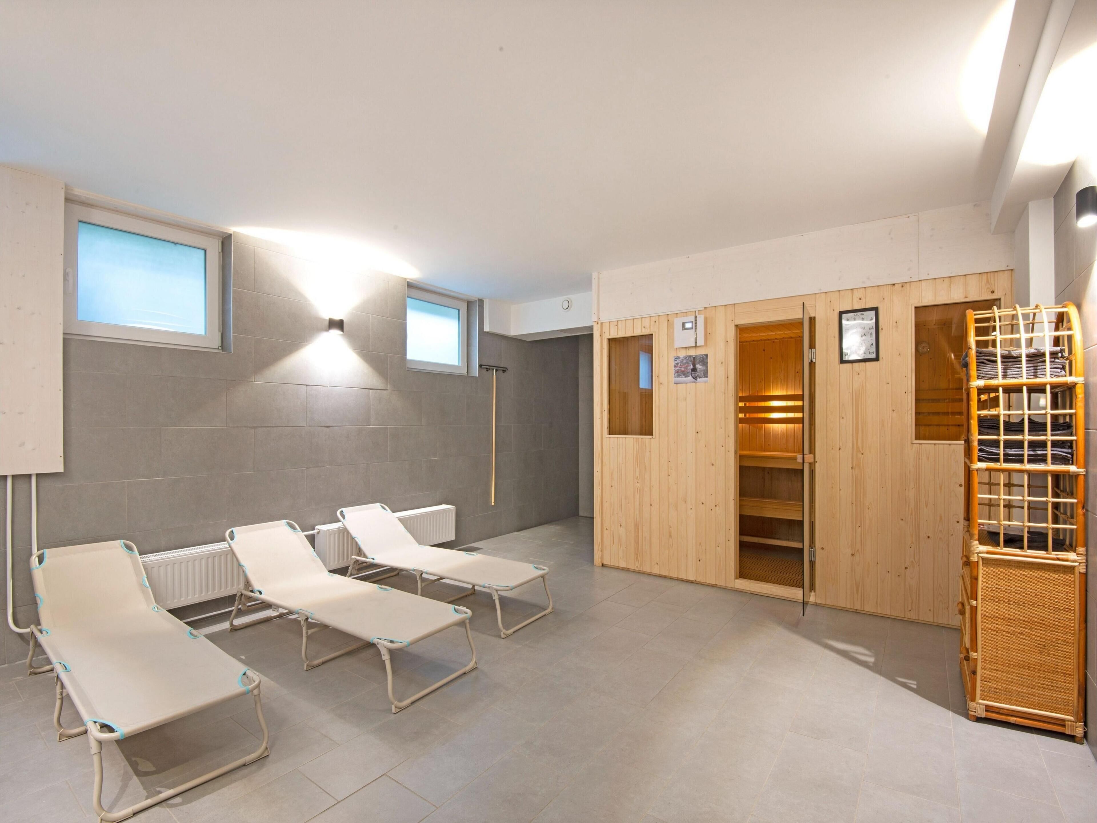 Un sauna avec des bancs en bois et une structure en bois.