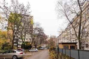 Stroll along a tree-lined street, surrounded by multi-story buildings with inviting balconies and windows.