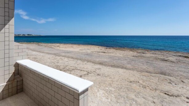 A beach view from a balcony with a tiled floor and a white ledge. - Vacation home Enrica by Interhome (Marina di Mancaversa)