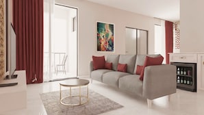 A modern living room with a grey sofa, red cushions, a round coffee table, and a painting on the wall. - Hypnose Hotel (Lubumbashi)