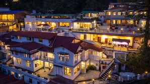 A multi-story hotel with balconies, a central courtyard, and outdoor seating areas. - India Hotel - Mall Road Nainital - Lake View (Nainital)