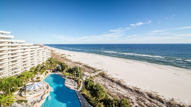 A resort with a large pool, beach access, and ocean views.