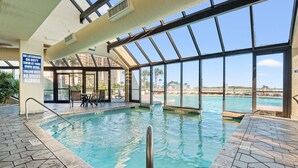 An indoor swimming pool with clear glass walls, a tiled floor, and a sign warning of shallow water and no diving allowed. - FAMILY FAVORITE!! NEW UPGRADES!  Booking for Summer NOW! (Myrtle Beach)