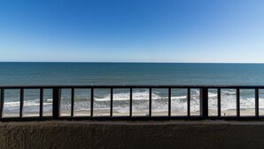 A beach view with a railing in the foreground. - Beach Retreat Oceanfront King Room 7th Floor (Myrtle Beach)