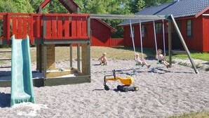 A playground with a slide, swings, and sand play area. - "Cvetanka" - 200m from the sea by Interhome (Nexø)
