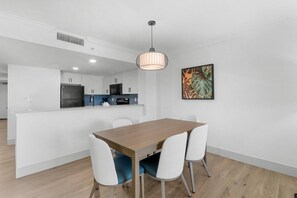 Enjoy meals in this stylish dining area with a wooden table and pendant light.