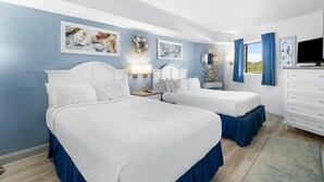 A hotel room with two beds, a TV, a dresser, and artwork on the walls. - Coastal Getaway 4th Flr 3BR Angle Ocean View Condo (Myrtle Beach)