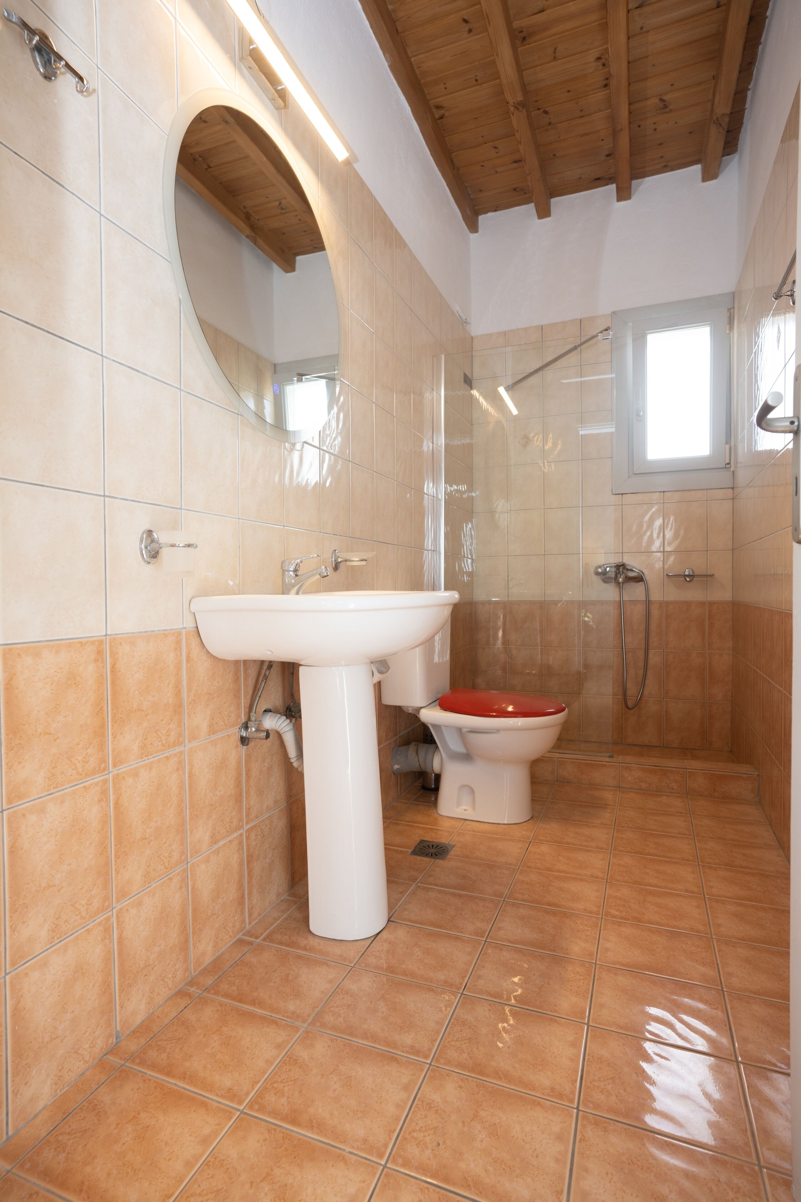 A bathroom with a sink, toilet, and shower.