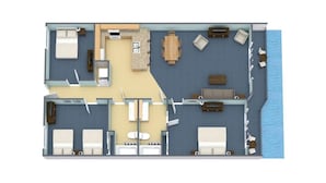 A hotel room layout with a bed, two bedside tables, a desk, a chair, a small bathroom, and a view of the sea.