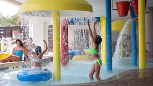 A water play area with multiple water jets and a pool.