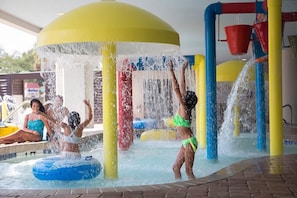 A water play area with multiple water jets and a pool.
