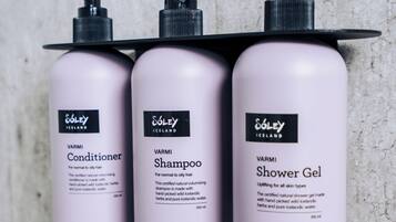 Three bottles of Soley Iceland products: conditioner, shampoo, and shower gel, each with a pump dispenser.