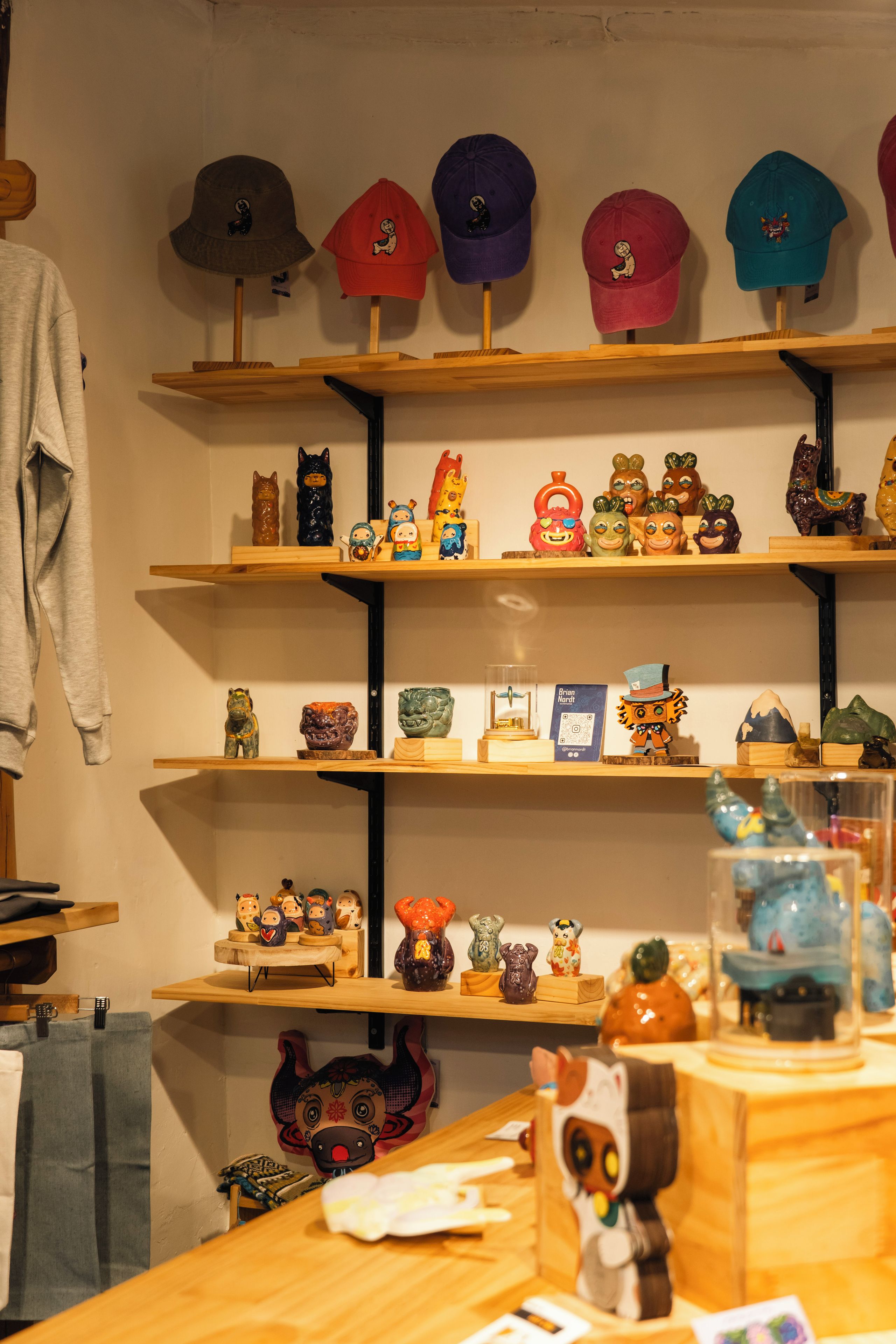 A display of hats and figurines on shelves.