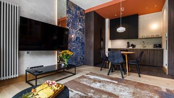 Premium Apartment, 1 Bedroom, Balcony, City View | Living area | 54-inch Smart TV with cable channels, stereo
