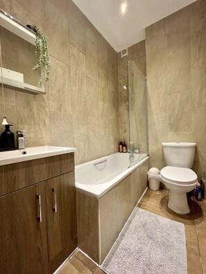 Enjoy a relaxing soak in the bathtub or refreshing shower, complemented by a vanity and toilet.