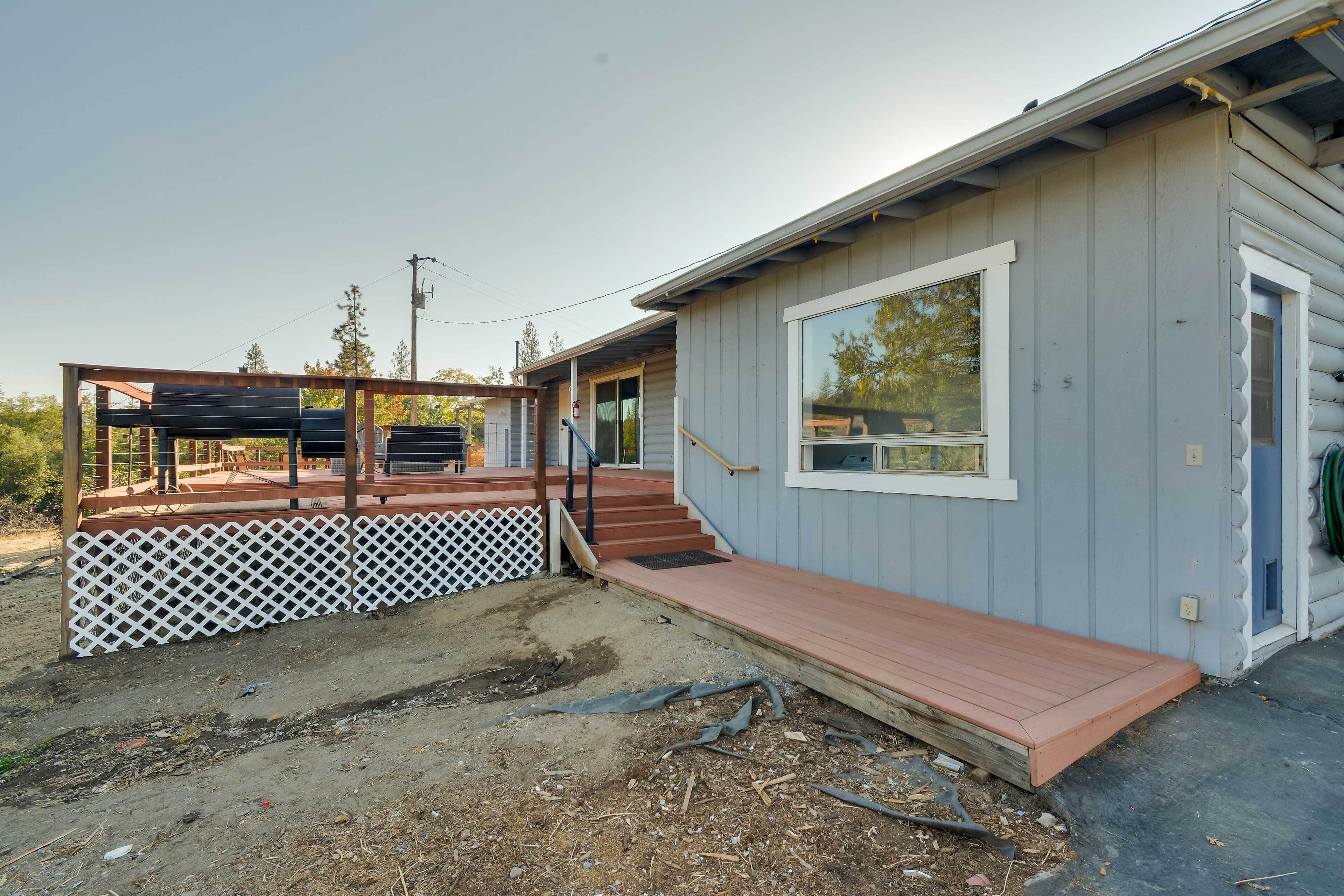 A single-story building with a wooden deck and a covered outdoor area.