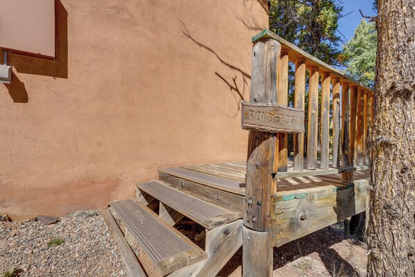 A wooden deck with a sign reading "PONDEROSA" and a rustic wooden railing.