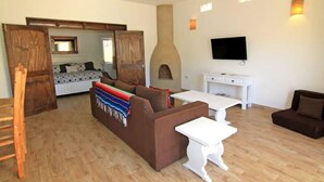 A living room with a sofa, a coffee table, a TV, and a fireplace. - 8AP Beautiful 1st Floor Condo, Pool Side, Cerritos
 (El Pescadero)