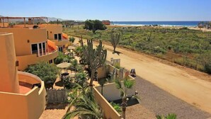 A hotel with multiple floors, outdoor seating, and a view of the beach. - 8AP Beautiful 1st Floor Condo, Pool Side, Cerritos
 (El Pescadero)