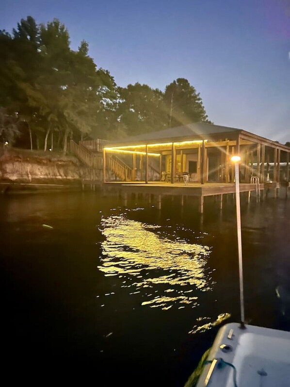 A waterfront property with a covered patio area and a boat dock.