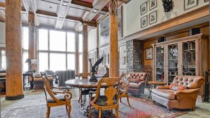 A spacious room with a large dining table surrounded by chairs, a leather sofa, and a cabinet with glass doors. - Mccoy Peak Lodge #107 1 Bedroom Condo by RedAwning (Avon)