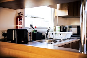 Cabin | Private kitchen | Fridge, microwave, oven, stovetop