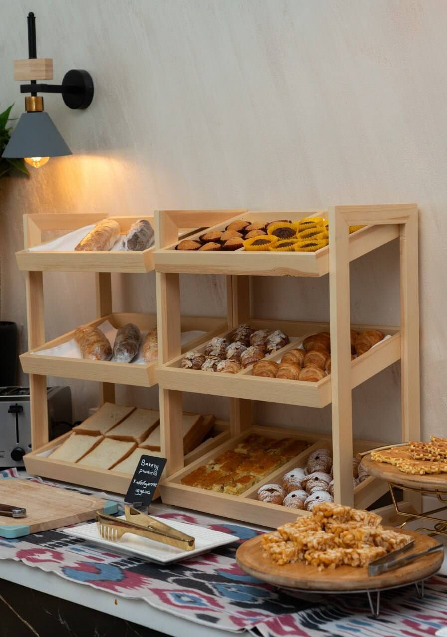 A bakery display with various baked goods and a sign indicating the bakery's name.