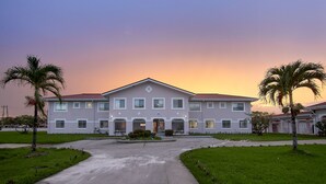 A large, single-story building with a symmetrical facade, multiple windows, and a central entrance. - King Studio - One
 (Georgetown)