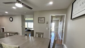A dining area with a large wooden table and chairs, a ceiling fan, and a framed inspirational quote on the wall. - In ground Pool with unbeatable views, ASV (Otego)