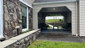 A covered patio with outdoor furniture, a stone wall, and a sign reading "FRESH HERBS." - In ground Pool with unbeatable views, ASV (Otego)